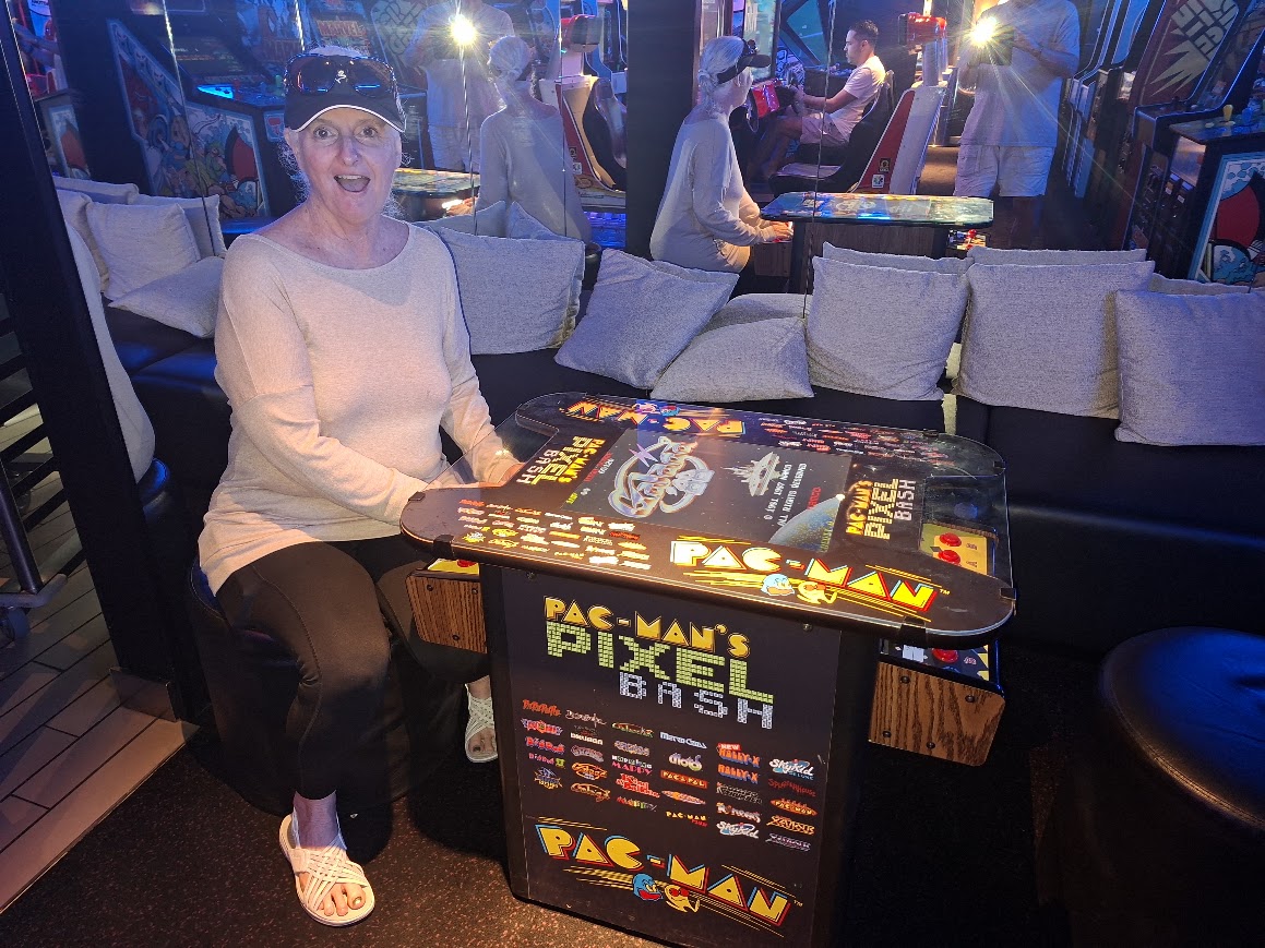 Judy playing Ms. Pac-Man aboard Virgin Voyages Resilient Lady